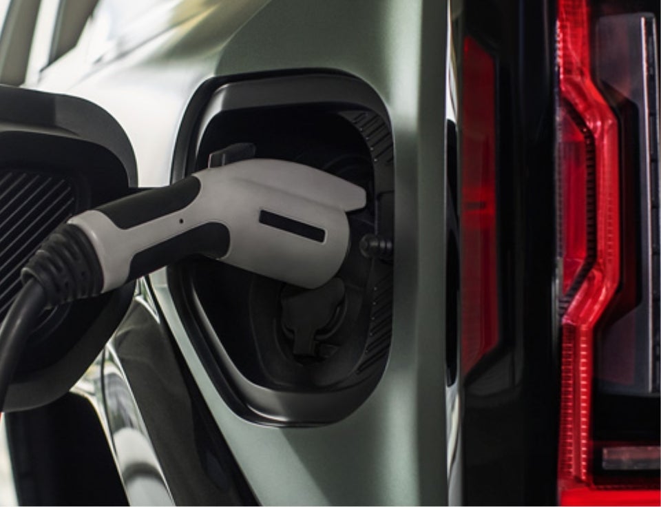 Close up of charging port with charger plugged in on a GMC Hummer EV SUV - Harry Robinson Buick GMC in Fort Smith AR